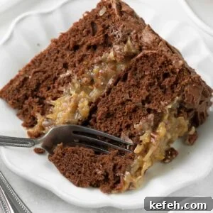 Slice of German chocolate cake with a fork taking a bite