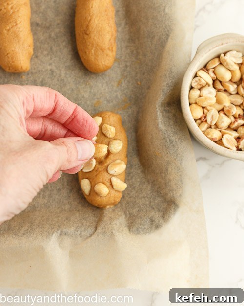 Adding the peanuts to the bars.