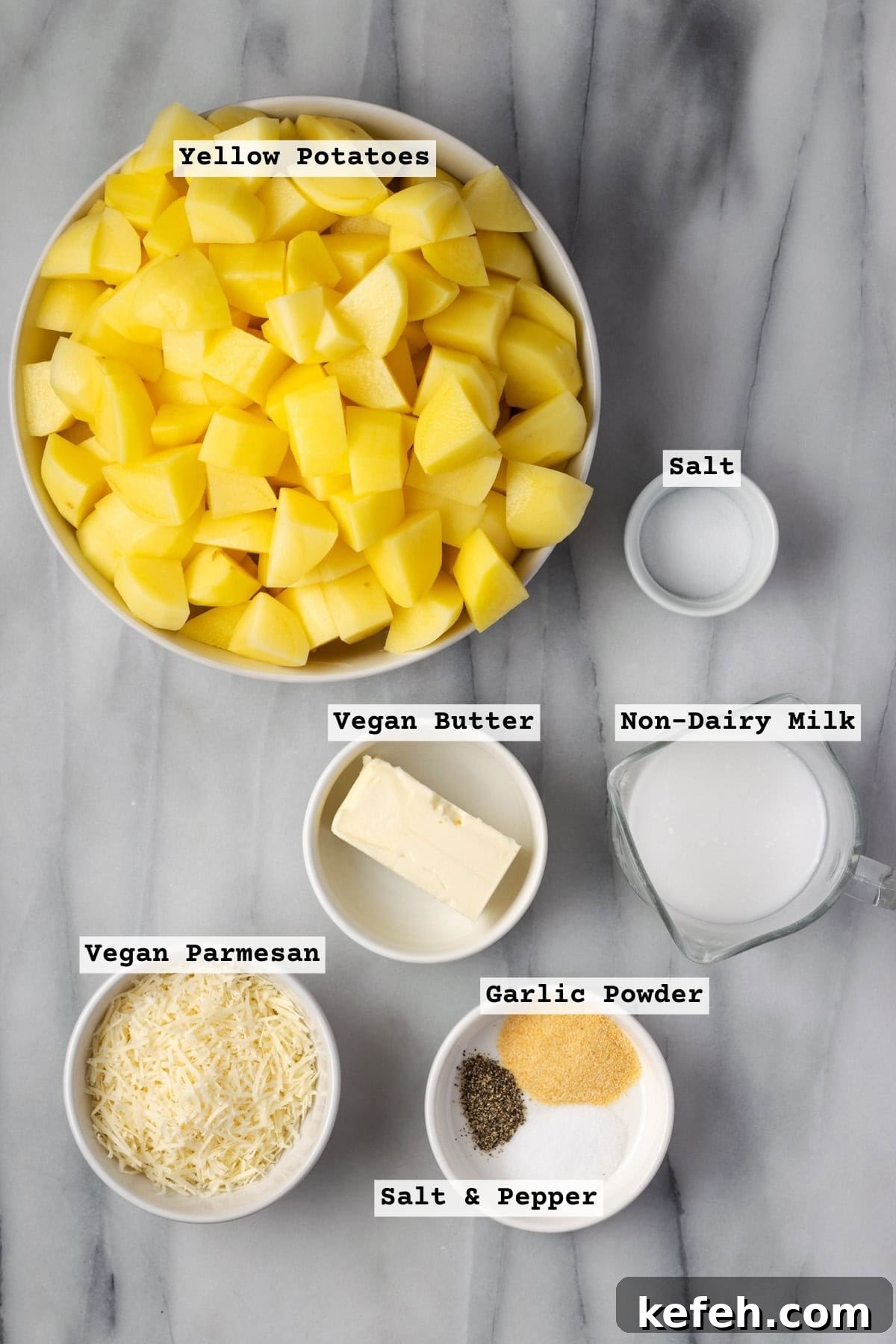 Ingredients for gluten free and dairy free mashed potatoes sitting on a marble countertop.