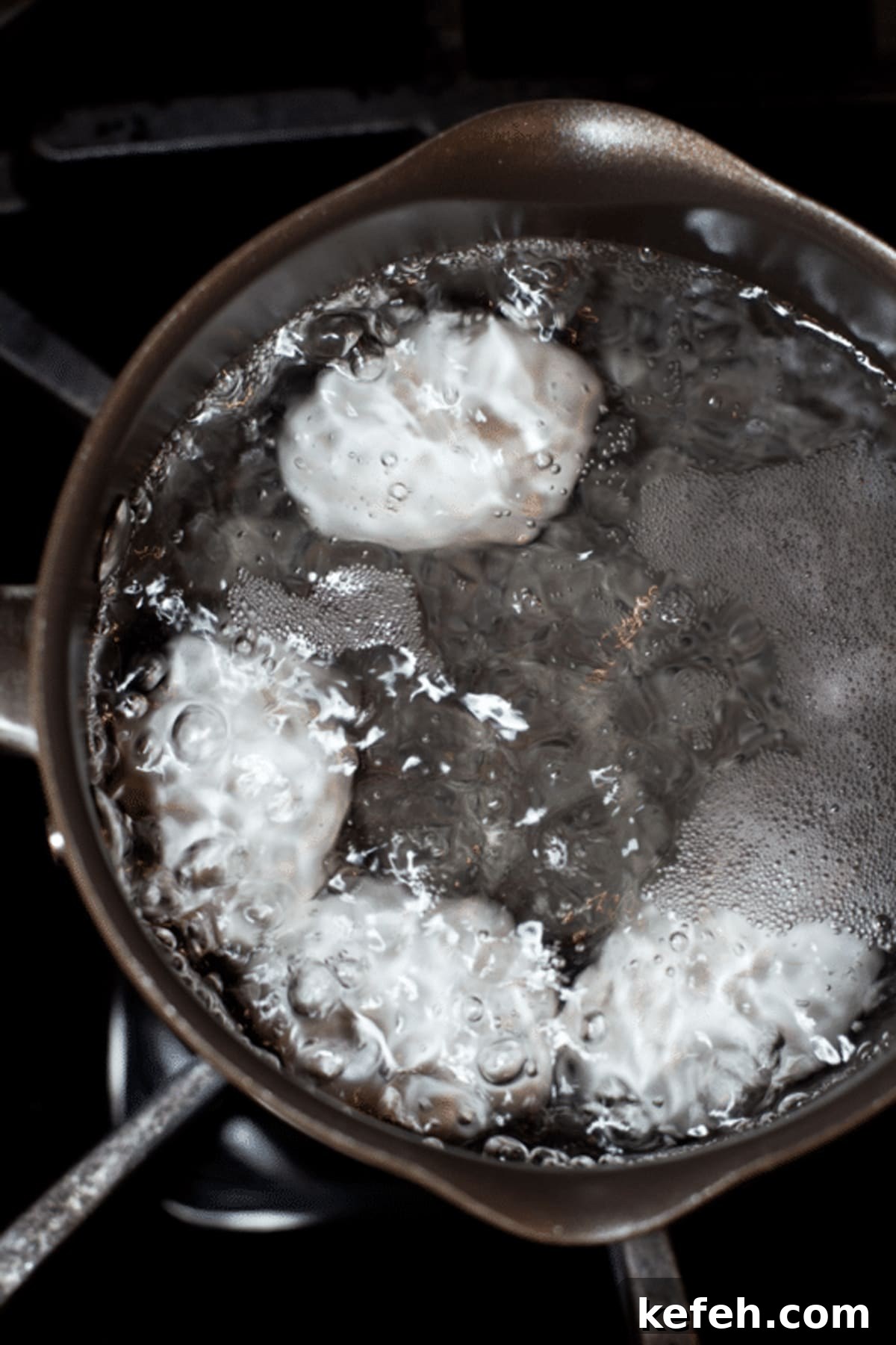 Eggs boiling in a pot of water.