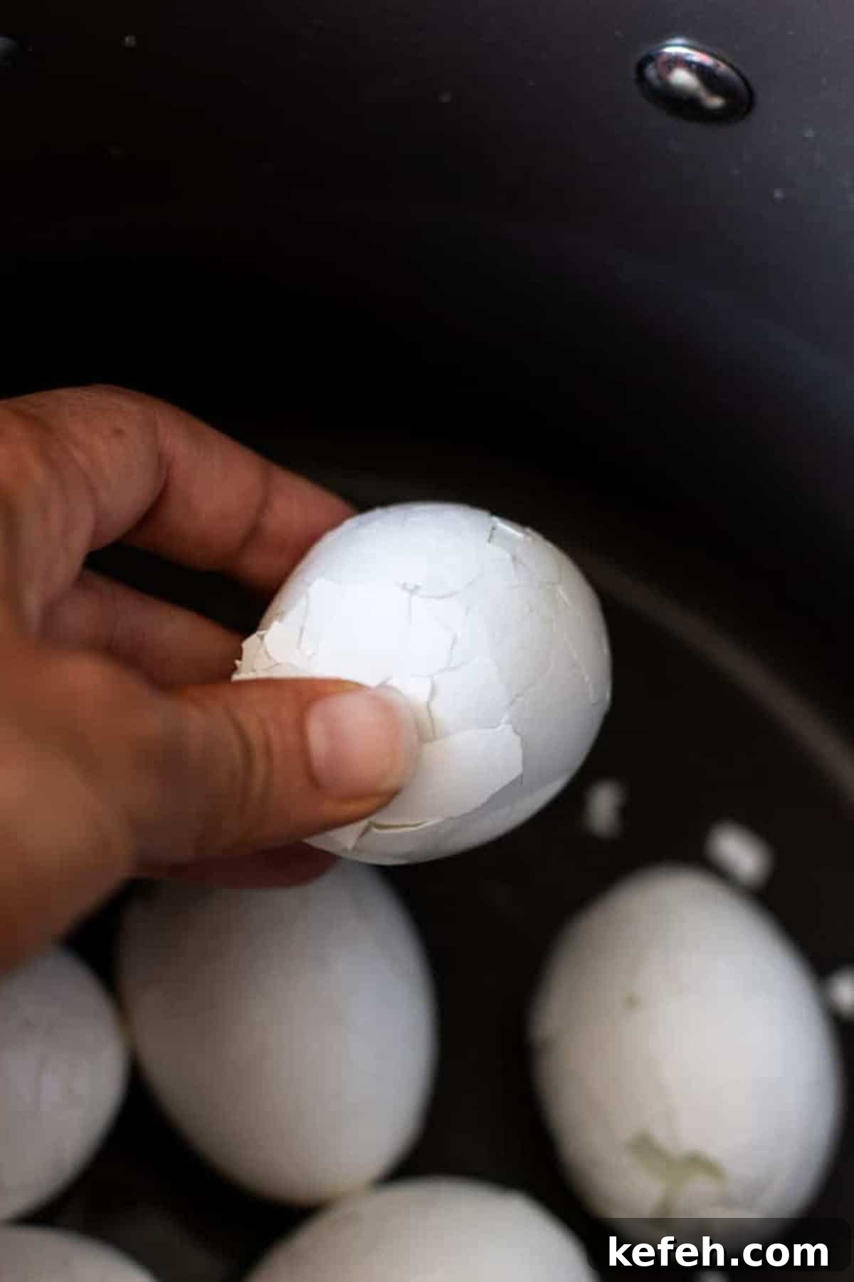 Person holding a cracked egg.