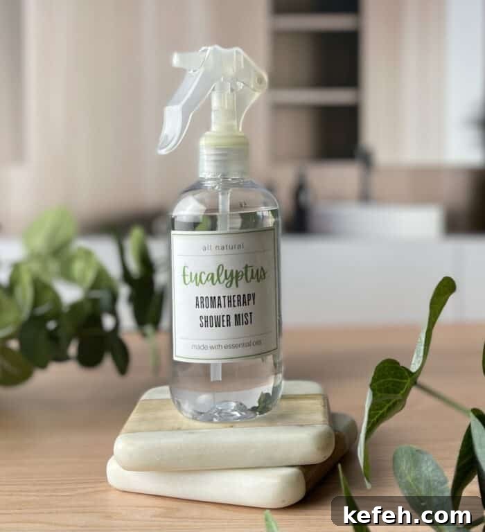 DIY Aromatherapy Shower Mist: Step-by-Step Recipe for Relaxing Scents 6 eucalyptus aromatherapy shower mist on 2 coasters next to eucalyptus branches on spa countertop