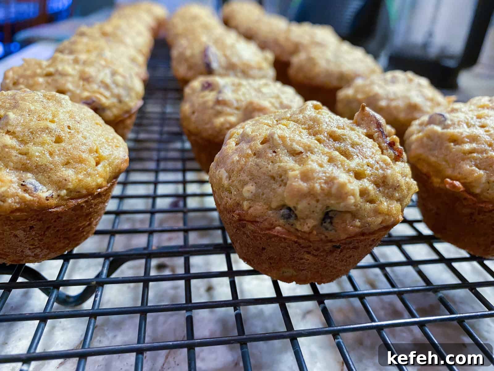 Carrot Banana Muffins with Cinnamon and Honey 11 Mini muffins on a cooling rack.