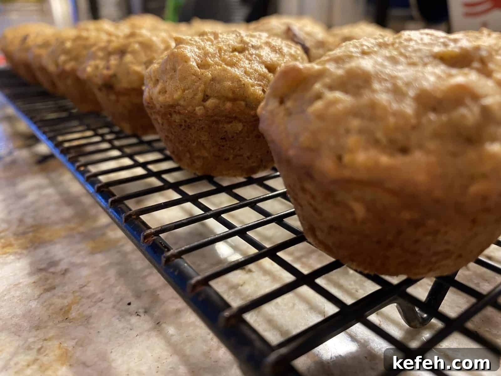 Carrot Banana Muffins with Cinnamon and Honey 3 Mini muffins lined up on a cooling rack.