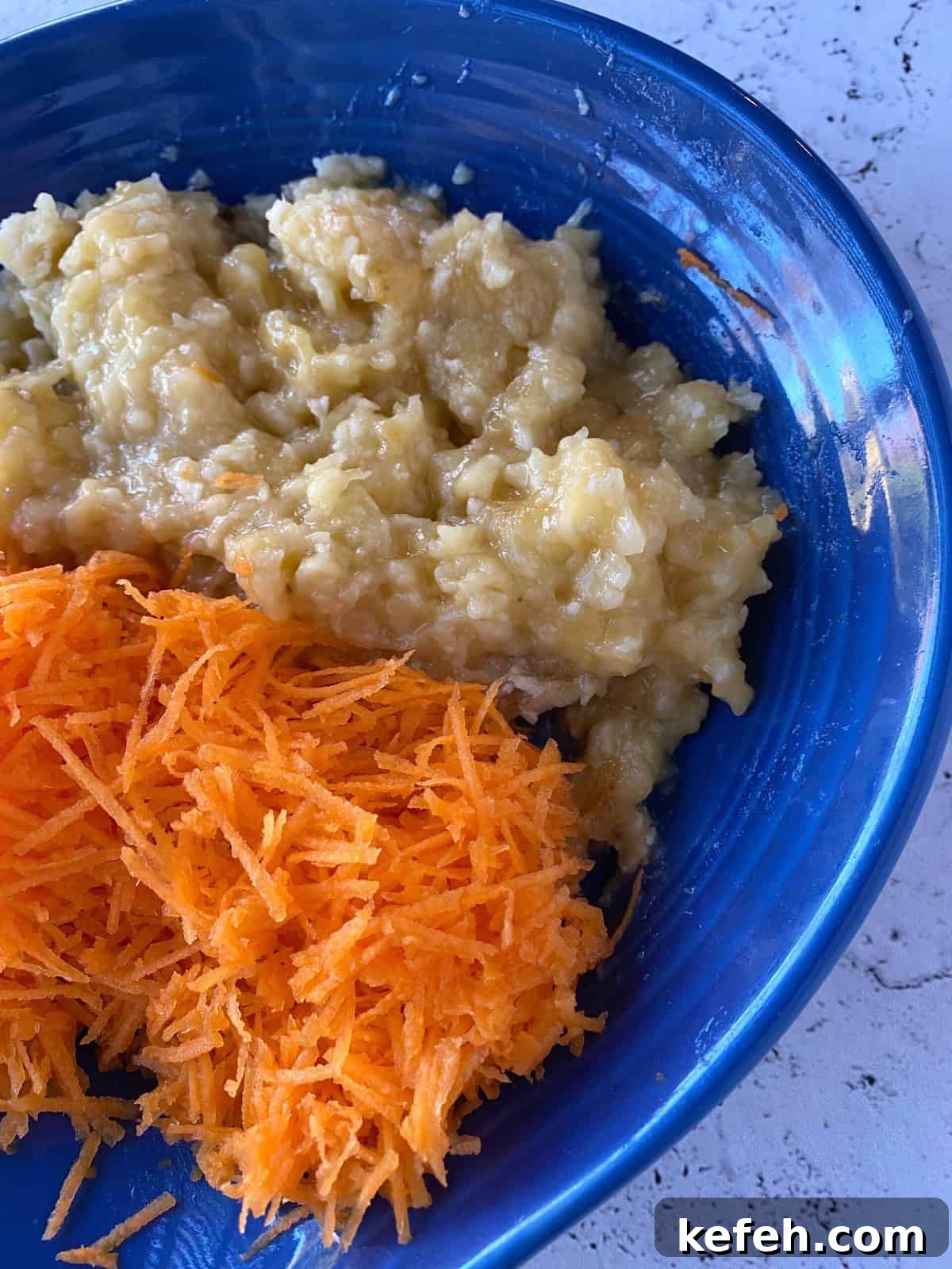 Carrot Banana Muffins with Cinnamon and Honey 6 Shredded carrots and mashed bananas in a dish.