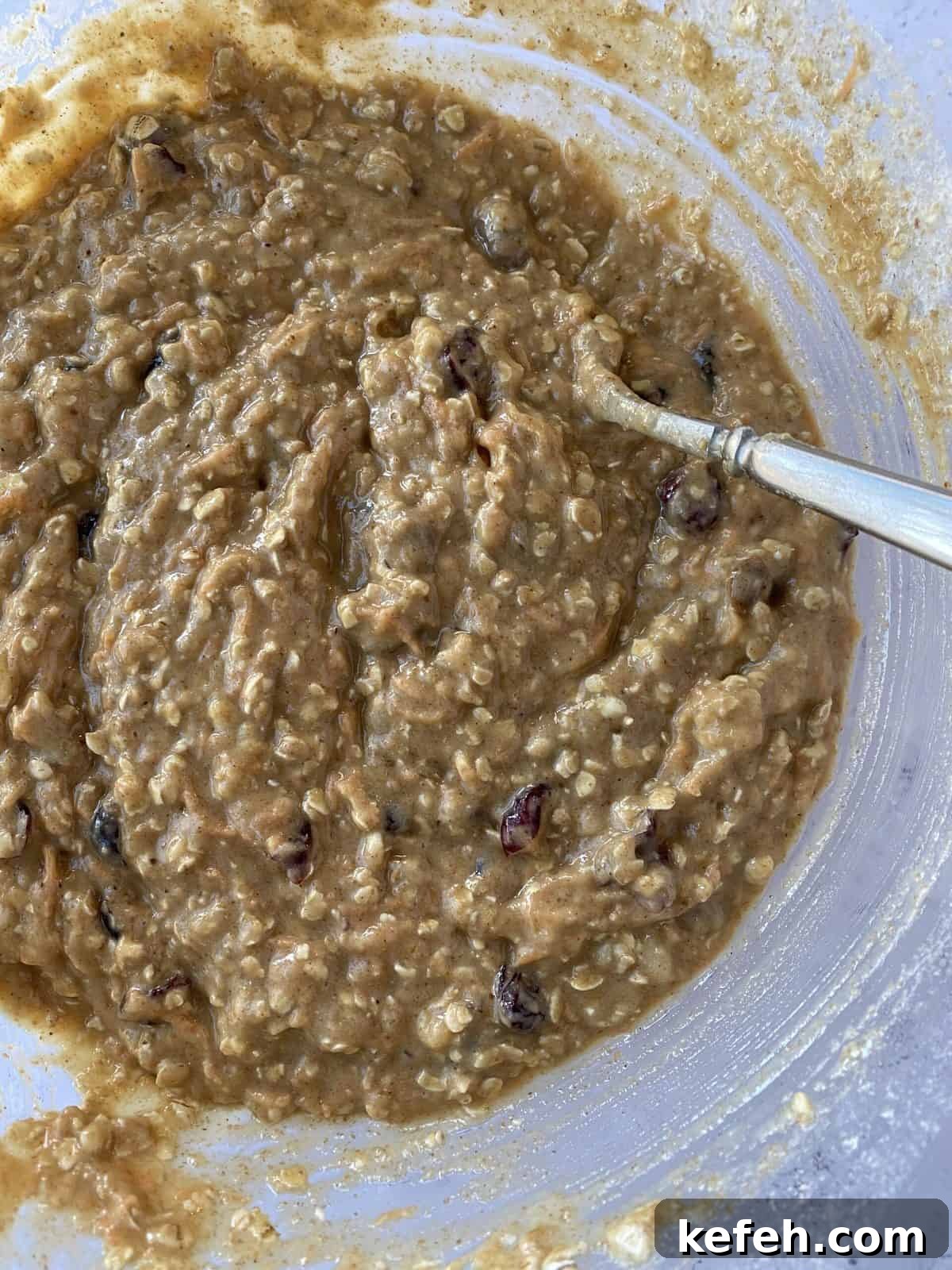 Carrot Banana Muffins with Cinnamon and Honey 9 Raw dough in a bowl with a spoon.