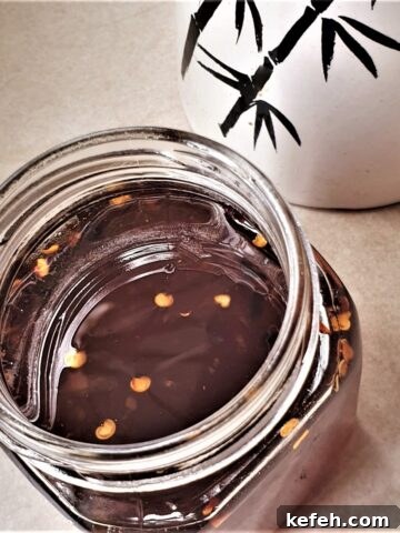 A jar of thai sweet chili sauce.