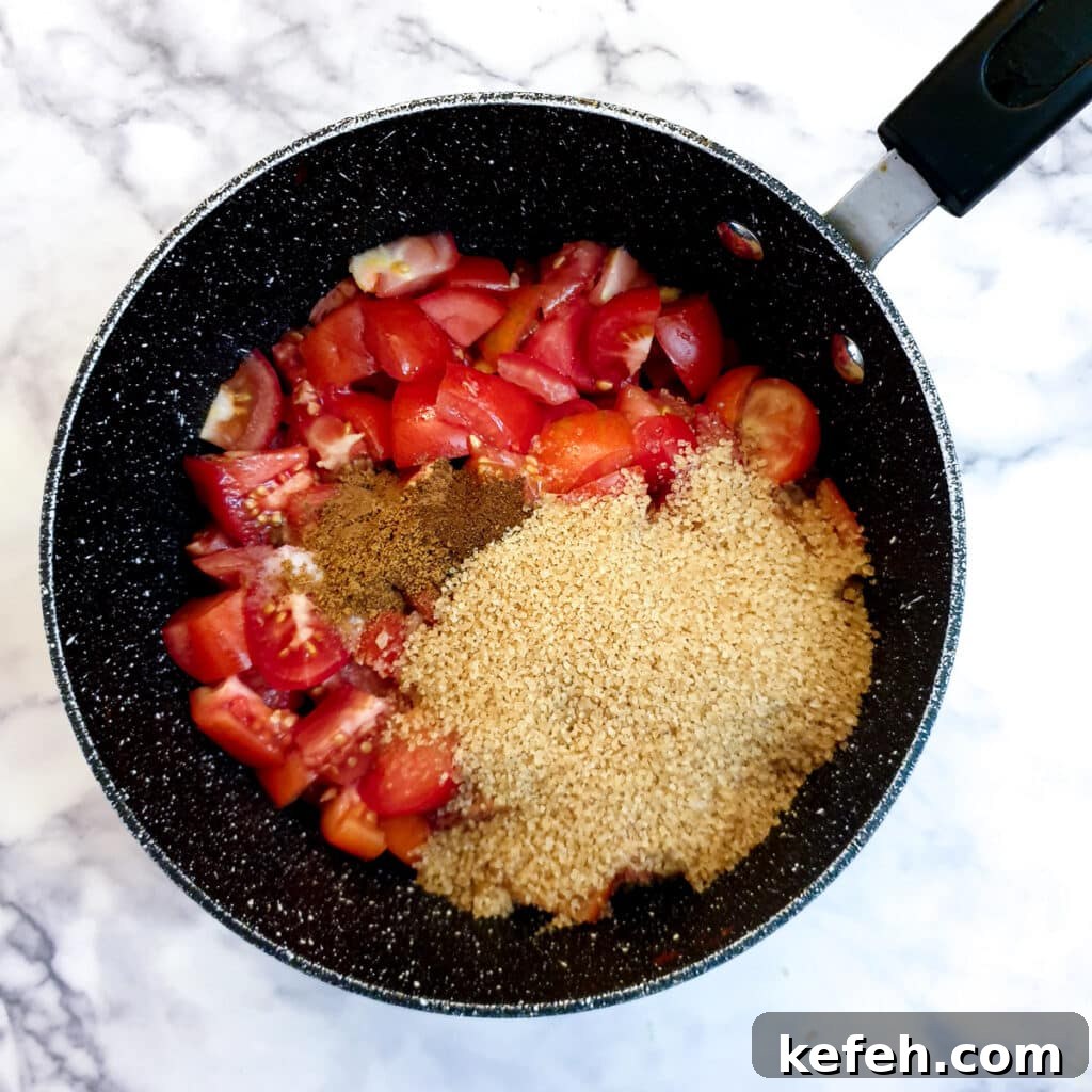 Chopped tomatoes, brown sugar, vinegar and spices in a saucepan.