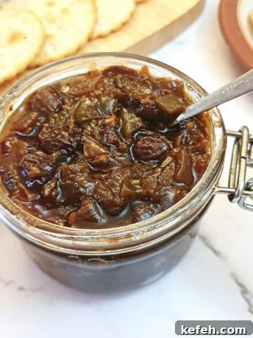 An open jar of green tomato chutney.