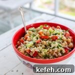 Red bowl filled with rice salad.