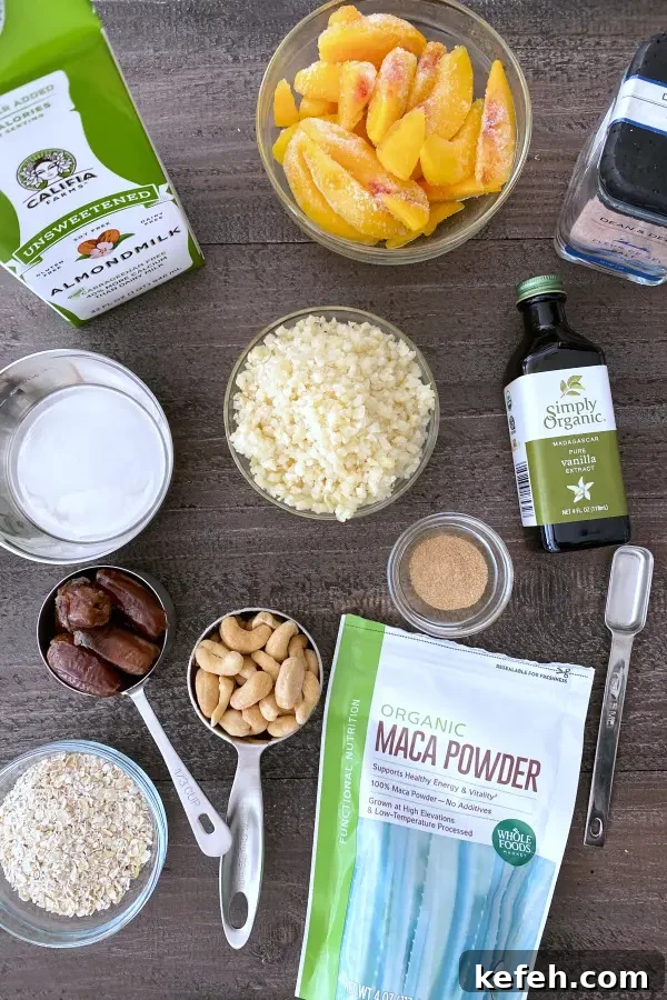 overhead view of ingredients in a peach smoothie: almond milk, peaches, frozen cauliflower, dates, cashews, oats...