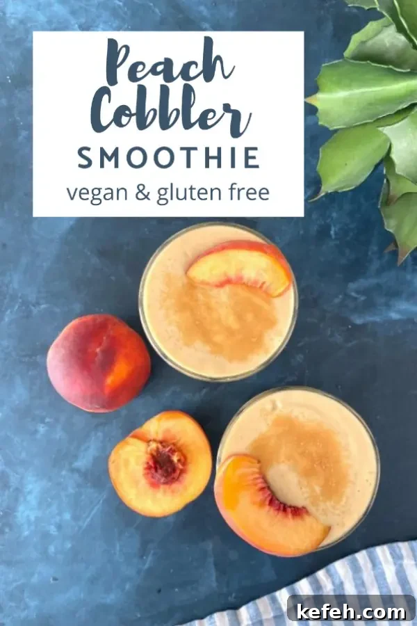 overhead view of two glasses of Peach Smoothie, garnished with a fresh peach slice and cinnamon, a fresh peach sliced in half next to the glasses, green leafy plant in background