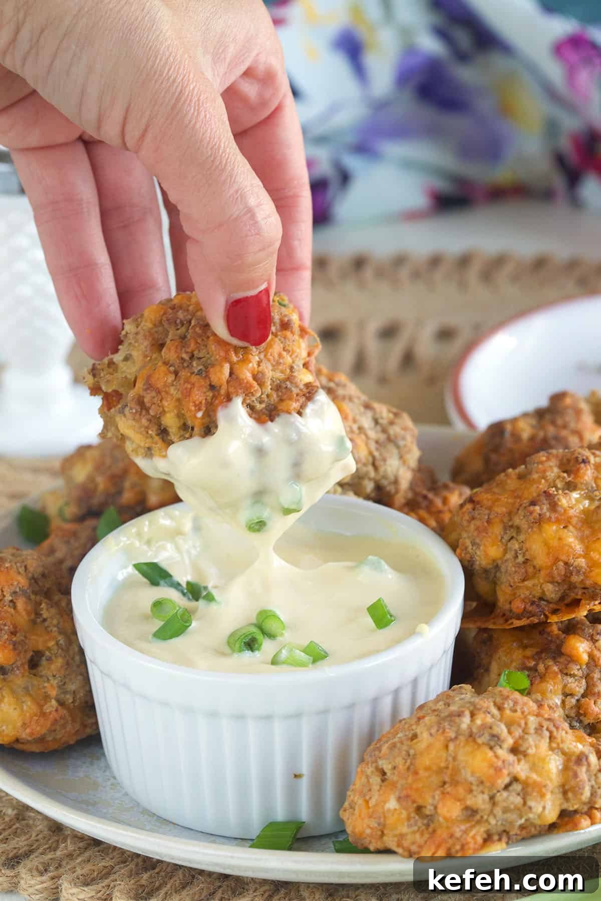 Irresistible Sausage Ball Recipe for Parties and Game Day 5 Sausage balls are being dipped into garlic aioli.