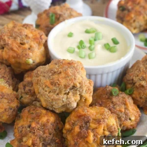 Irresistible Sausage Ball Recipe for Parties and Game Day 6 Sausage balls are placed on a plate next to a bowl filled with dipping sauce.