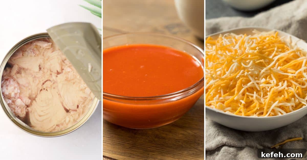 Canned tuna with an open lid, a bowl of red sauce, and a bowl of shredded cheese rest on a cloth, ready for transformation. Imagine these ingredients coming together in your next crock pot buffalo chicken dip adventure.