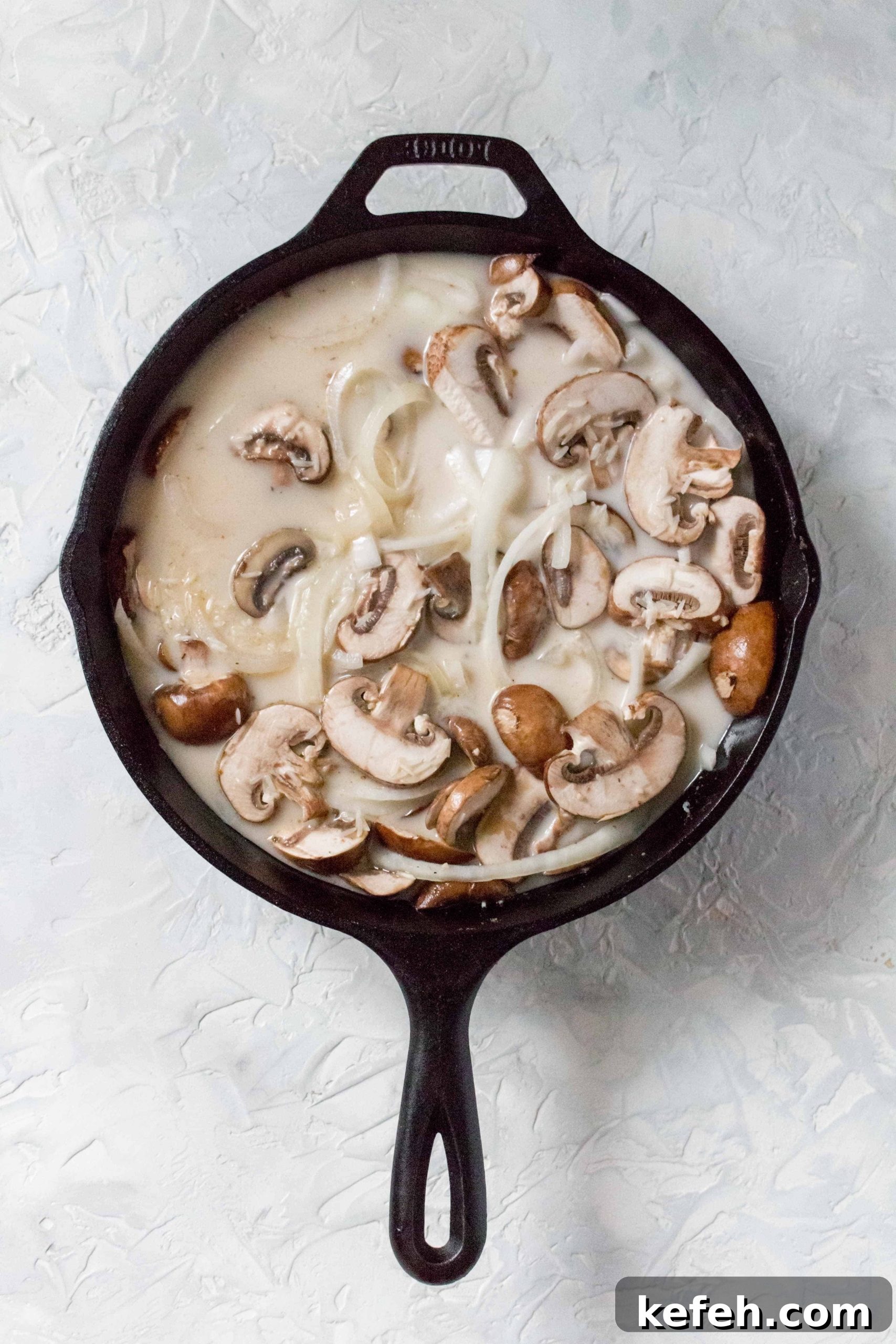 Skillet Chicken with Mushrooms, Peas & Creamy Rice 5 one pot chicken and rice in cast iron: Add in the rice, chicken broth, heavy cream, and dried basil. Stir.