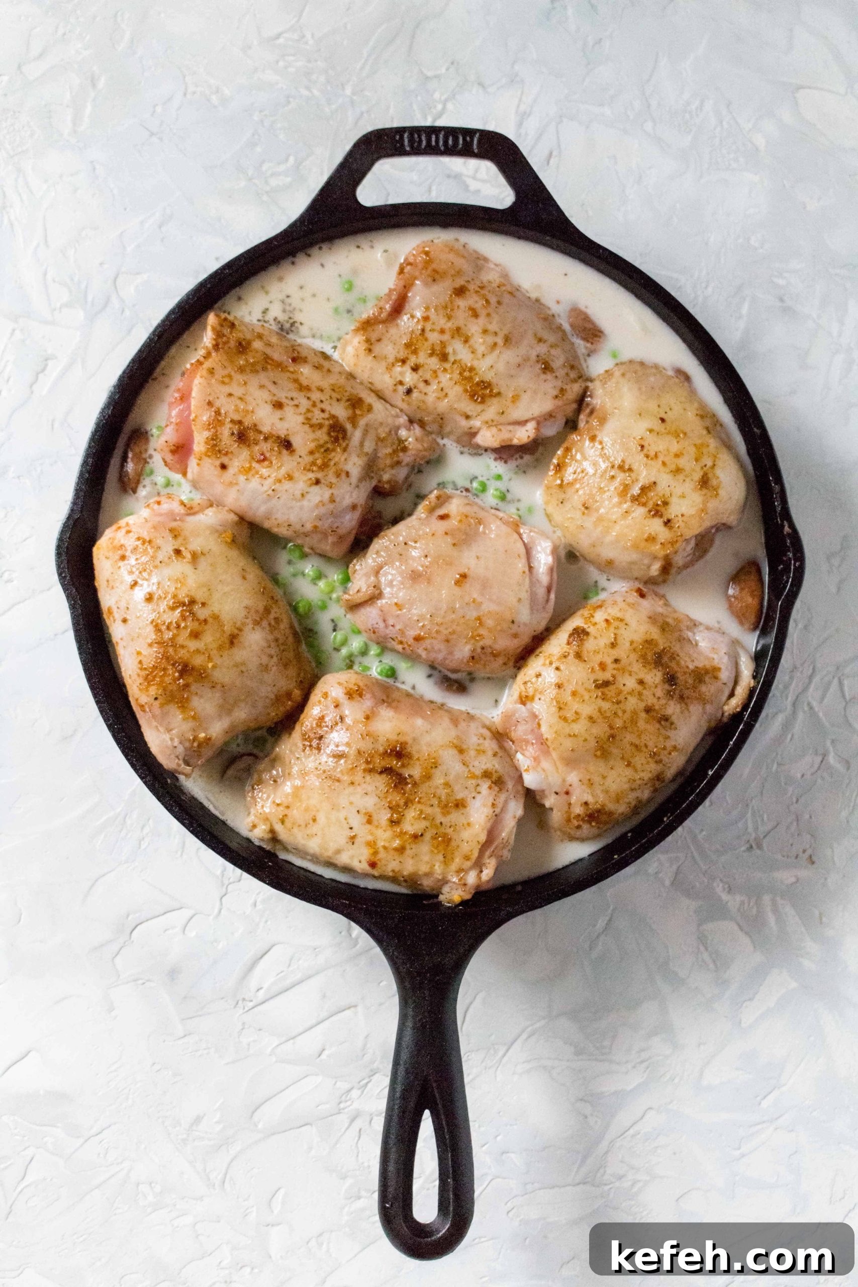 Skillet Chicken with Mushrooms, Peas & Creamy Rice 6 Place a lid (or tin foil) onto the cast iron and bake for 35 minutes. After, remove the lid (or tin foil) and bake for 10 more minutes. Broiling near the end if you prefer extra crispy skin.
