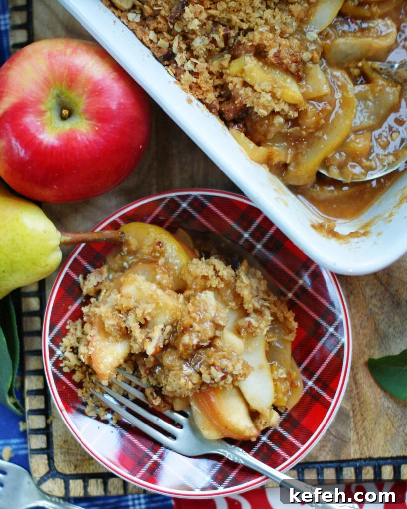an overhead photo of a serving of apple pear crisp showing the texture of the topping and the cooked sliced apples.