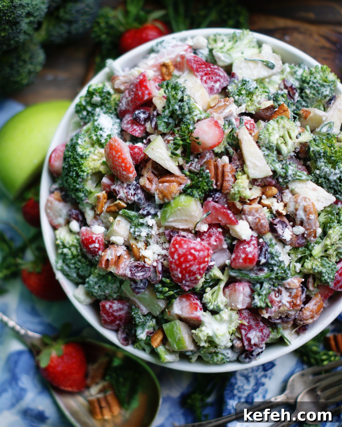 An overhead look at a classic potluck or cookout salad with crunchy broccoli and a tangy, creamy homemade dressing.