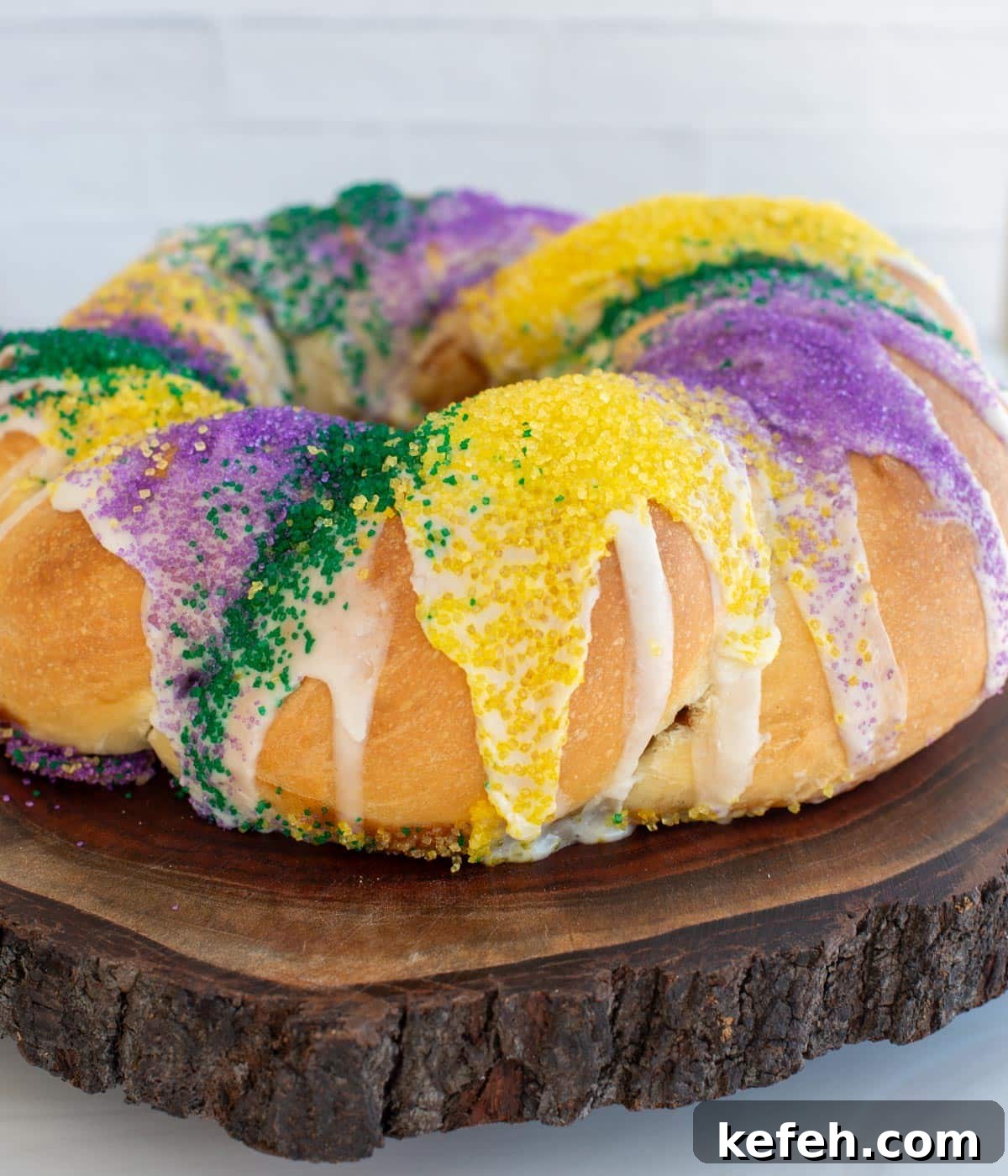 Sourdough King Cake Recipe: How to Make Festive Mardi Gras Bread 12 A large king cake covered in sprinkles and sitting on a wooden board.