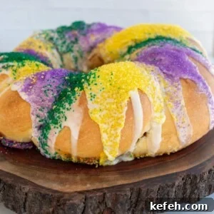 Sourdough King Cake Recipe: How to Make Festive Mardi Gras Bread 13 A sourdough king cake on a wooden board decorated with sprinkles.
