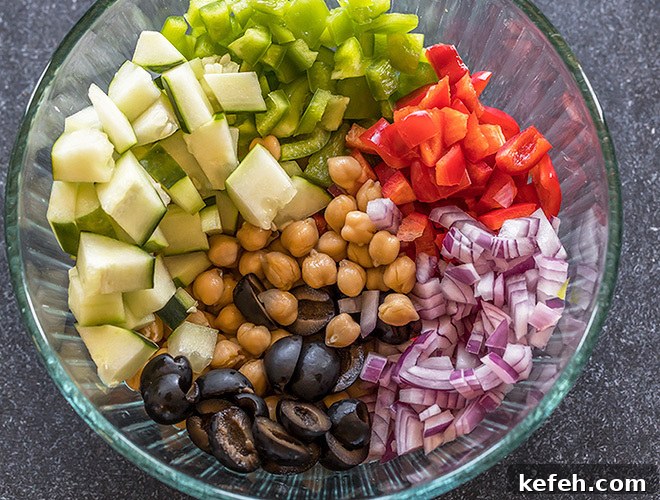 Mediterranean Chickpea Salad with Feta, Cucumber & Lemon Dressing 4 bowl with chickpeas, chopped onion,olives, cucumber and pepper