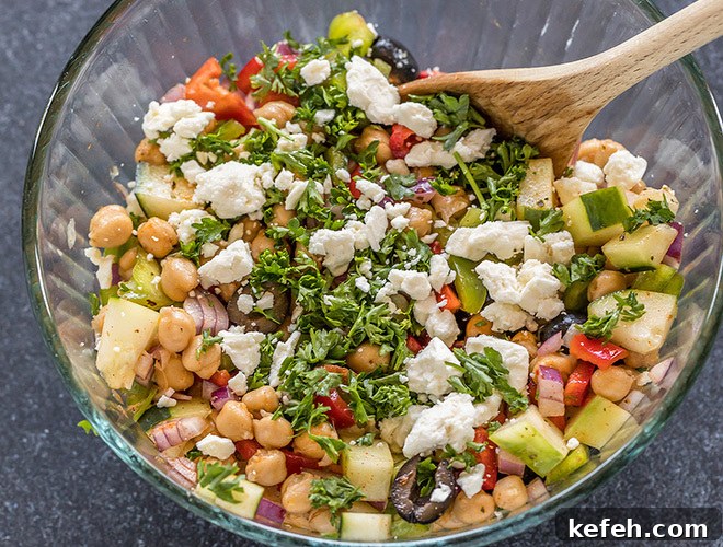 Mediterranean Chickpea Salad with Feta, Cucumber & Lemon Dressing 7 bowl with chickpeas, chopped onion,olives, cucumber, pepper, parsley and feta cheese