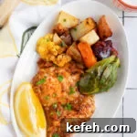 Last-Minute Rosh Hashanah Prep: Quick Guide to Ready Your Home and Table 12 Harissa chicken and vegetables on a white plate with a slice of lemon.