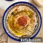 Last-Minute Rosh Hashanah Prep: Quick Guide to Ready Your Home and Table 16 Top down view of preserved lemon hummus in blue bowl.