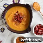 Last-Minute Rosh Hashanah Prep: Quick Guide to Ready Your Home and Table 21 soup in purple bowl with copper spoon and dukkah and arils