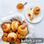 Last-Minute Rosh Hashanah Prep: Quick Guide to Ready Your Home and Table 27 Challah rolls in a basket with honey on the side.