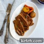 Last-Minute Rosh Hashanah Prep: Quick Guide to Ready Your Home and Table 4 Sliced brisket on a small white plate with potatoes and carrots and knife and fork nearby.