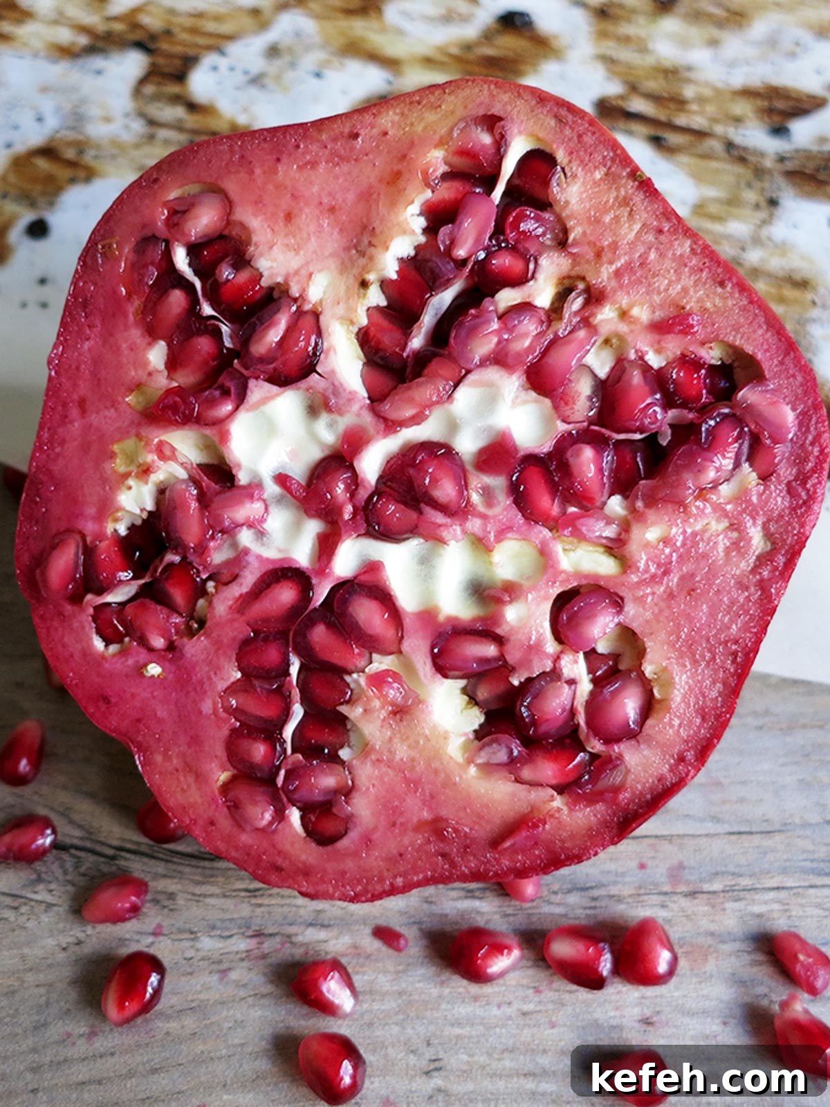 Last-Minute Rosh Hashanah Prep: Quick Guide to Ready Your Home and Table 33 Straight on view of a pomegranate that's been cut open to reveal the seeds inside.