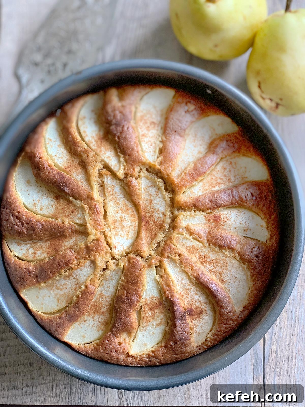 Last-Minute Rosh Hashanah Prep: Quick Guide to Ready Your Home and Table 38 Pear cake still in baking pan with some whole pears on the side.