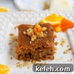 Last-Minute Rosh Hashanah Prep: Quick Guide to Ready Your Home and Table 39 Honey orange cake on a white plate with slices of citrus in the background.