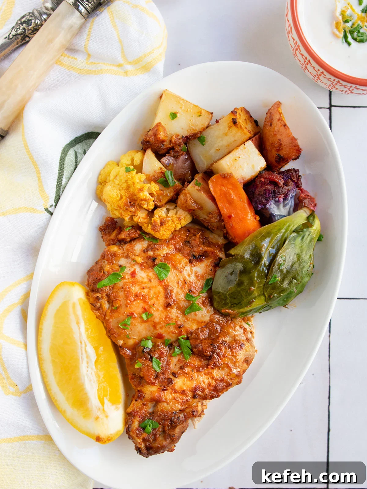 Last-Minute Rosh Hashanah Prep: Quick Guide to Ready Your Home and Table 9 A white plate showing harissa chicken and vegetables to introduce the chicken section.
