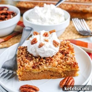 Styled plate with a slice of dump cake topped with whipped cream and pecans, with whipped cream bowl in background.
