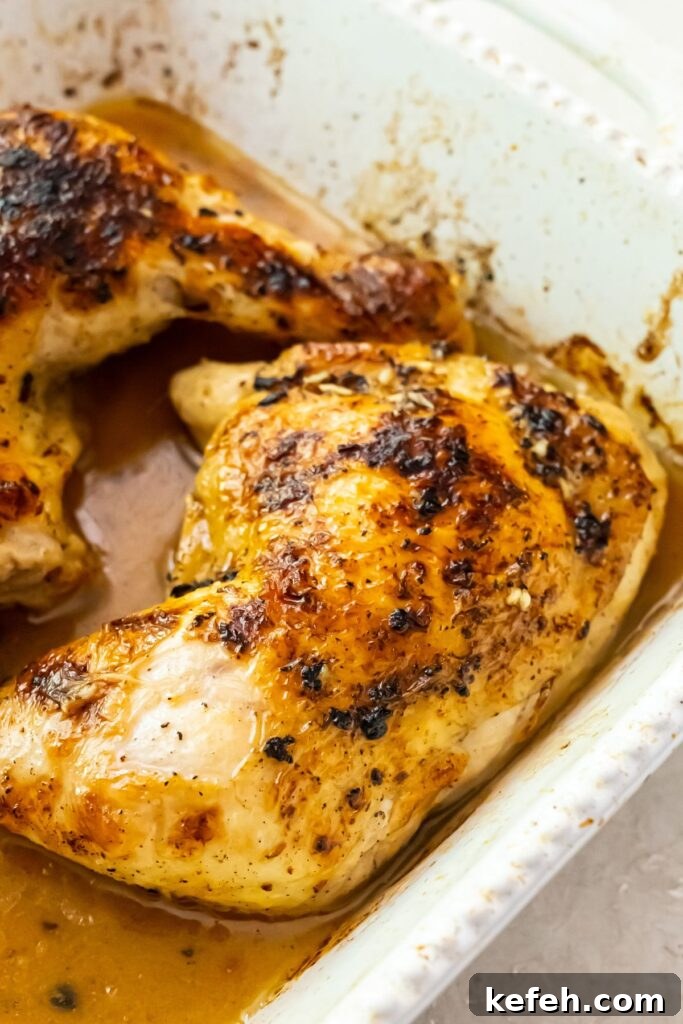 broiled chicken quarters in a white baking dish