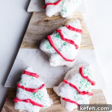 Little Debbie Christmas Tree Cakes Copycat Recipe for Holidays 20 White chocolate Christmas tree cakes on a marbled platter.