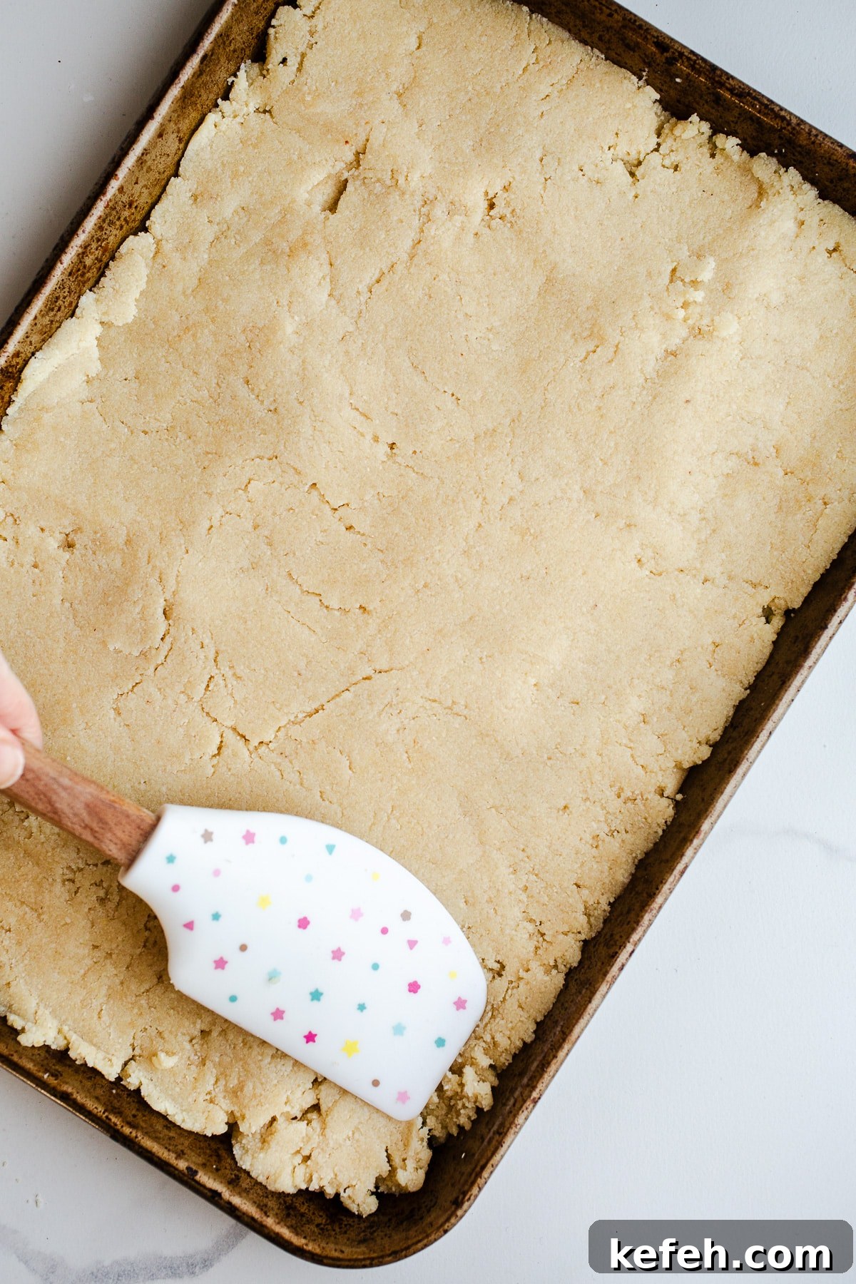Little Debbie Christmas Tree Cakes Copycat Recipe for Holidays 7 Cake dough spread in a baking sheet.