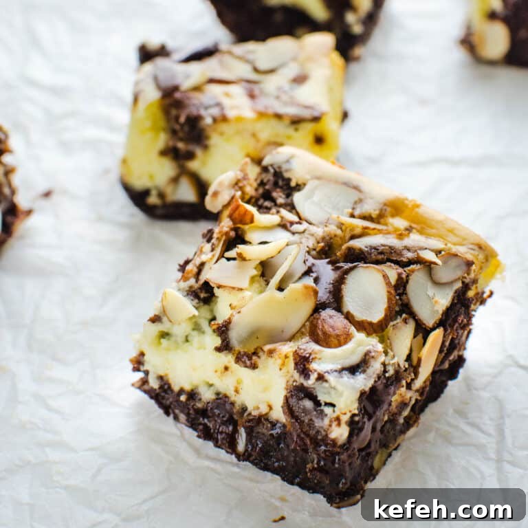 Decadent Cheesecake Brownie Squares: Fudgy Layers with Cream Cheese Swirl 12 cheesecake brownie bars cut into squares.