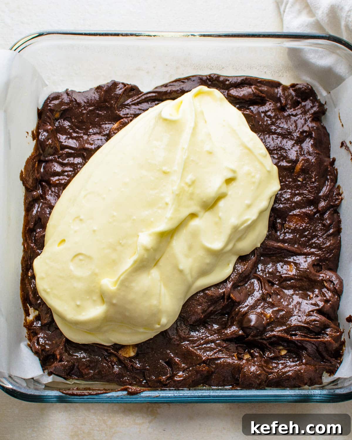 Decadent Cheesecake Brownie Squares: Fudgy Layers with Cream Cheese Swirl 7 Adding the cream cheese layer.
