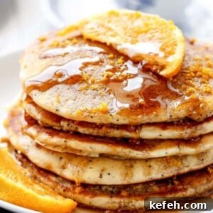 Orange Poppyseed Pancakes being stack on each other