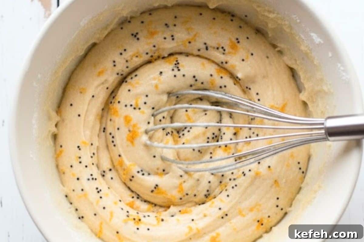 Fold in the orange zest and poppy seeds
