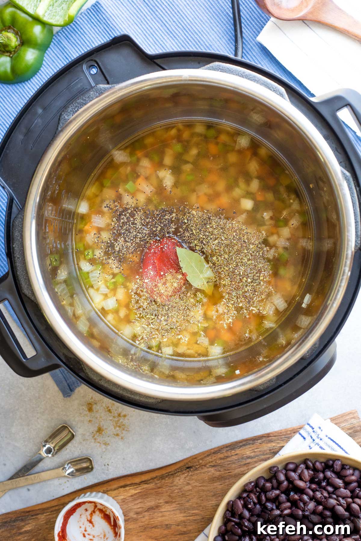 Instant Pot Black Bean Soup Recipe — Quick, Flavorful Meal 6 Broth, tomato paste and spices added to Instant Pot.