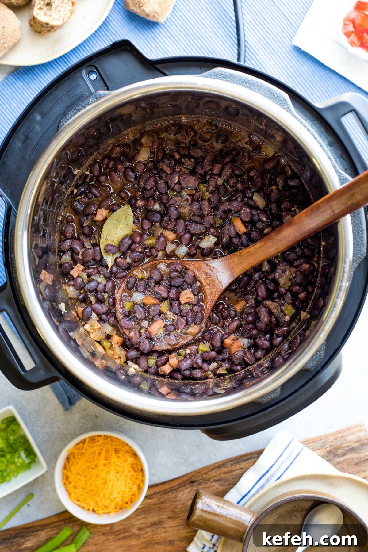 Instant Pot Black Bean Soup Recipe — Quick, Flavorful Meal 7 Finished soup, still in Instant Pot, with a wooden spoon dipping in.