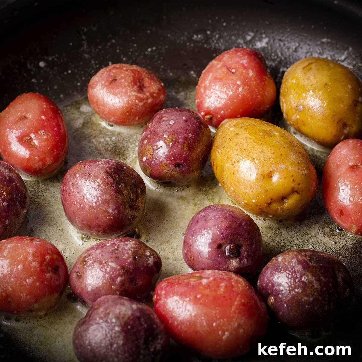 Corned Beef and Cabbage with Tangy Mustard Sauce (Instant Pot or Slow Cooker) 13 Small potatoes cooking in butter in a black skillet.