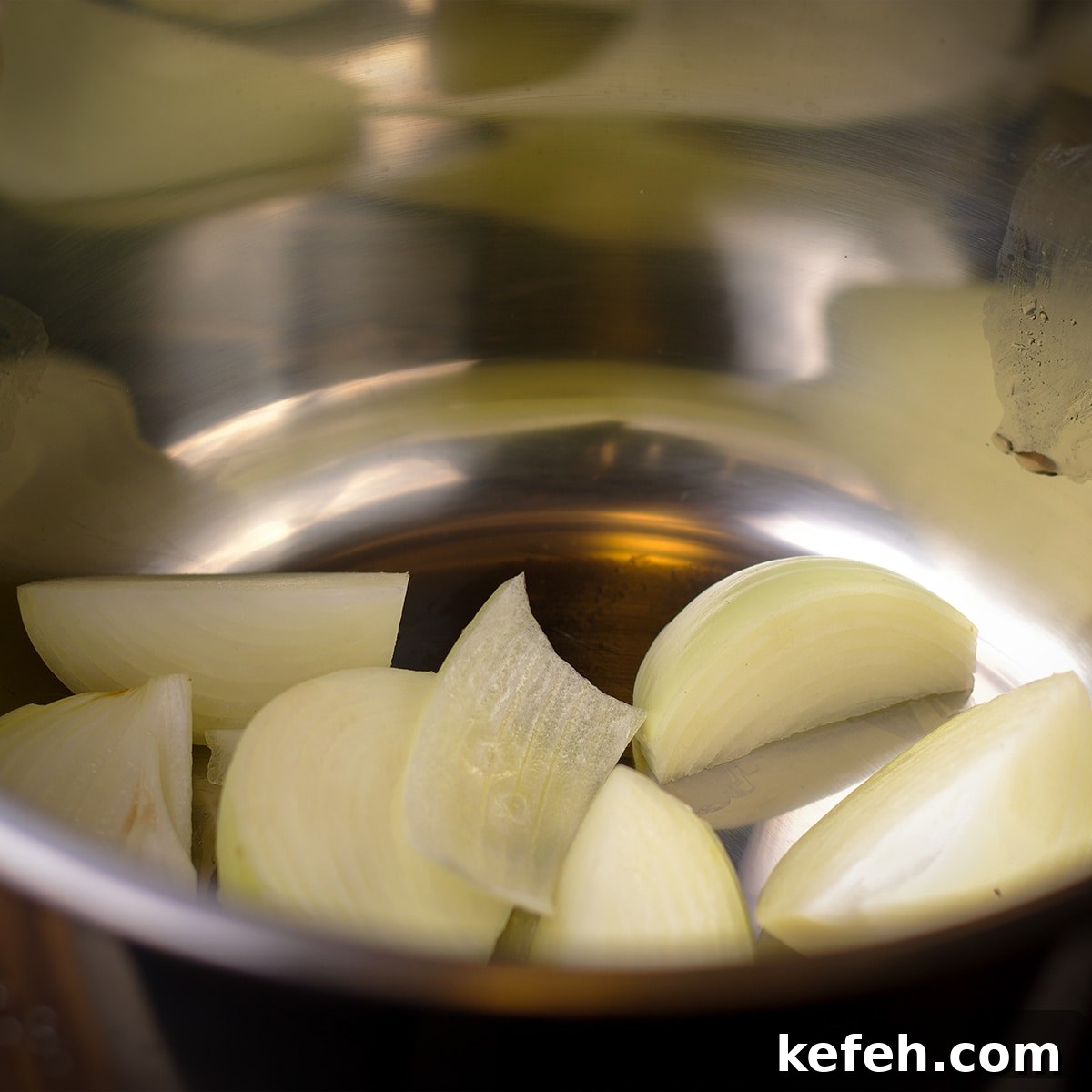 Corned Beef and Cabbage with Tangy Mustard Sauce (Instant Pot or Slow Cooker) 4 Slices of onion in the bowl of an instant pot.