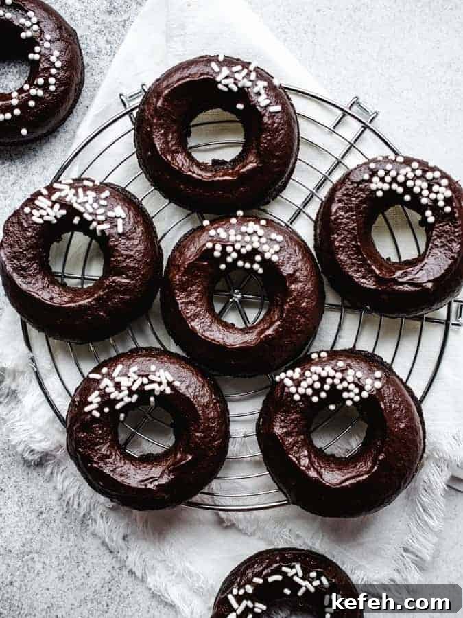 Vegan Baked Chocolate Fudge Doughnuts Recipe 3 Overhead of plant-based chocolate donuts on a round cooling rack