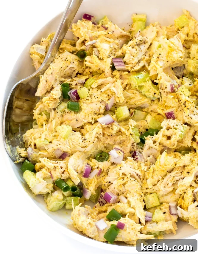 Curried Chicken Salad with Grapes & Toasted Almonds 4 Curry chicken Salad in a bowl with a spoon.